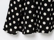 Black dress with white polka dots worn by a model on a white zara style long maxi sleeveless new year outfit holidays sexy women's clothing love bonito crew neck asian fit korean style clothing online shopping 