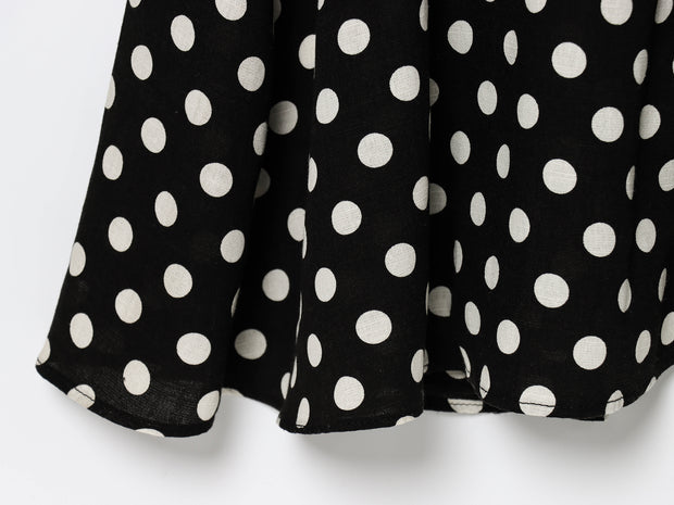 Black dress with white polka dots worn by a model on a white zara style long maxi sleeveless new year outfit holidays sexy women's clothing love bonito crew neck asian fit korean style clothing online shopping 