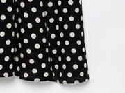 Black dress with white polka dots worn by a model on a white zara style long maxi sleeveless new year outfit holidays sexy women's clothing love bonito crew neck asian fit korean style clothing online shopping 